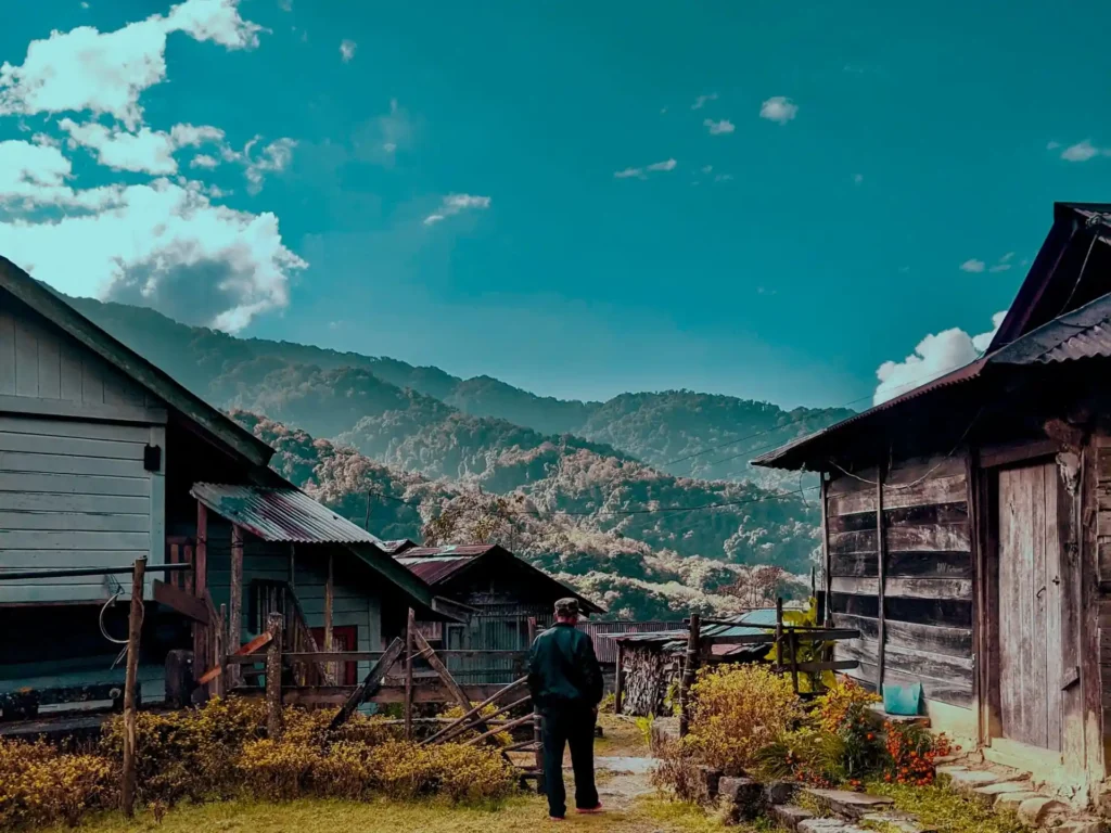 While strolling through a village, we came across an old man who was heading towards his farm, here captured in between beautiful landscape in Northeast India. The picturesque background enhances the surrounding the person lives in. Wonder how beautiful the heart of each person of this village would be.